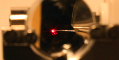 View through a lens: a laser beam strikes a nanotip. (Image: Dr. Michael Förster)