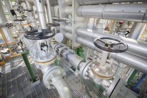 The image shows pipelines in a gas plant.